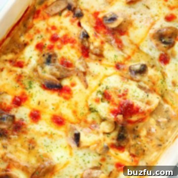 Chicken Gloria with melted cheese on top, in a rectangular baking dish.