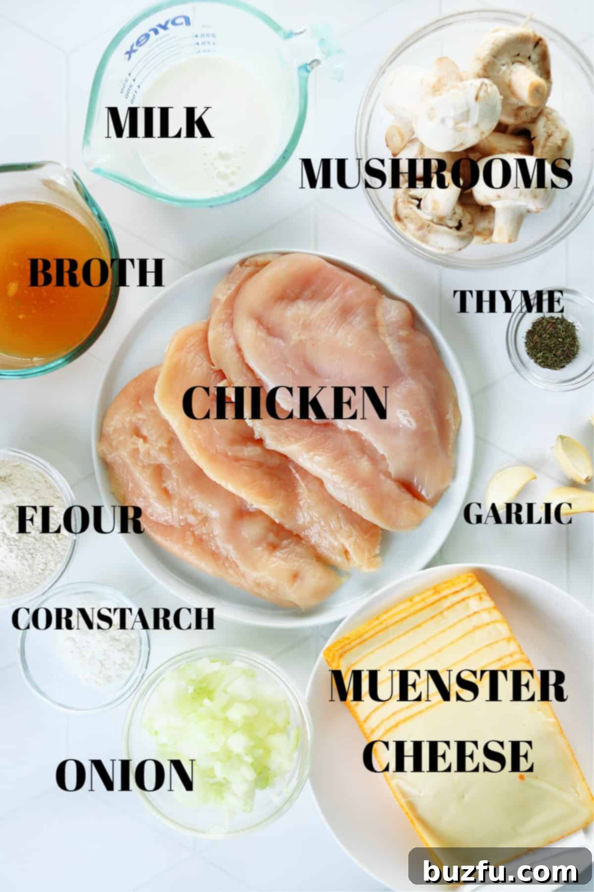 All ingredients for chicken Gloria dish in bowls and plates on a white tile board.