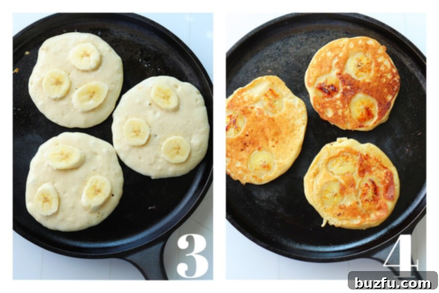 Golden Banana Pancakes 5 A cast iron griddle pan showing raw pancake batter with banana slices on one side and perfectly cooked, golden brown pancakes on the other side, illustrating the cooking process.