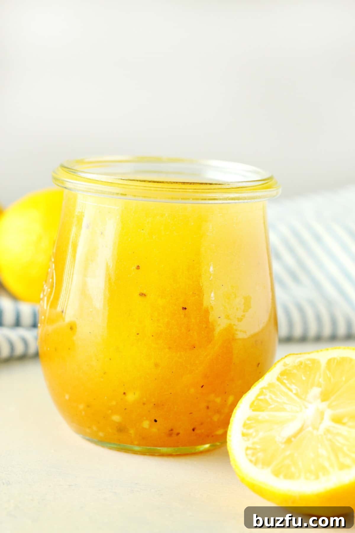 No-Fuss Salad Dressings 6 Salad dressing in a jar next to lemons.