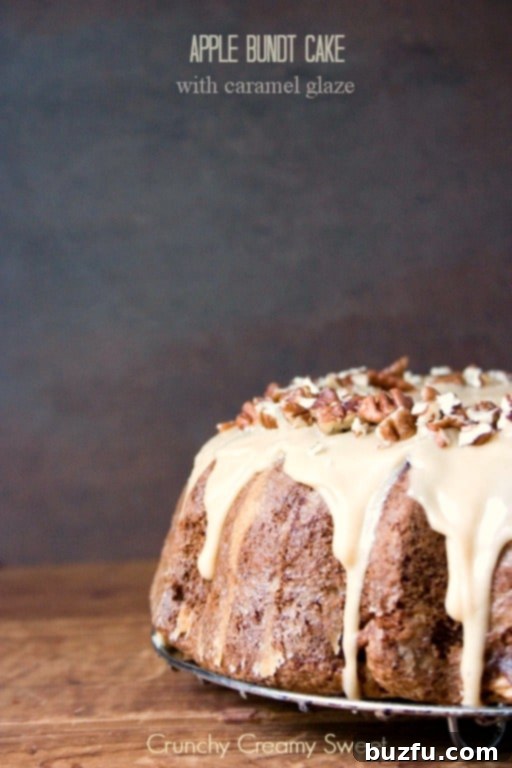 Apple Bundt Cake with Caramel Glaze - melt-in-your-mouth bundt cake with chunks of apples and sweet caramel glaze. Perfect Thanksgiving dessert idea! Apple Bundt Cake with Caramel Glaze and chopped pecans. A beautiful, golden-brown cake drizzled with amber caramel and sprinkled with nuts.
