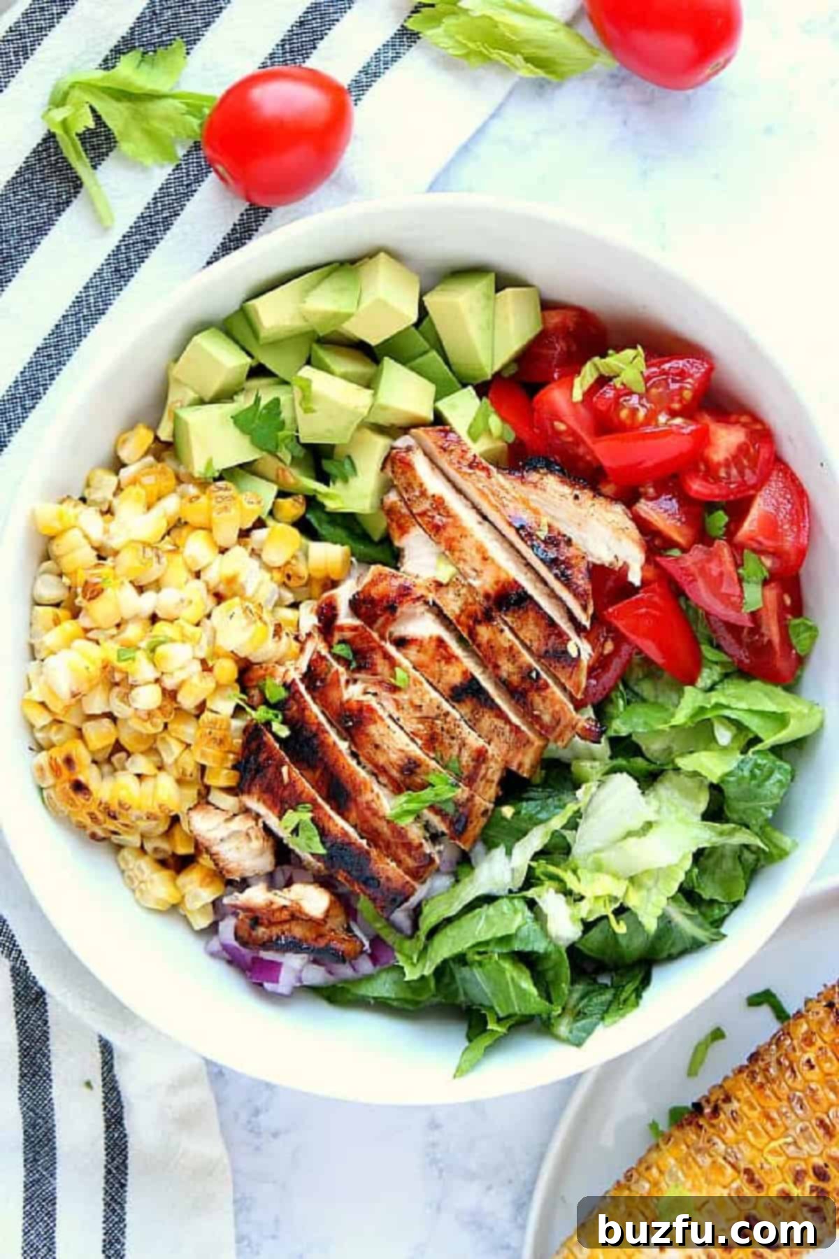 Week Six Meal Plan 6 A vibrant and fresh salad featuring perfectly grilled chicken, colorful vegetables, and a light dressing, presented in an elegant bowl.