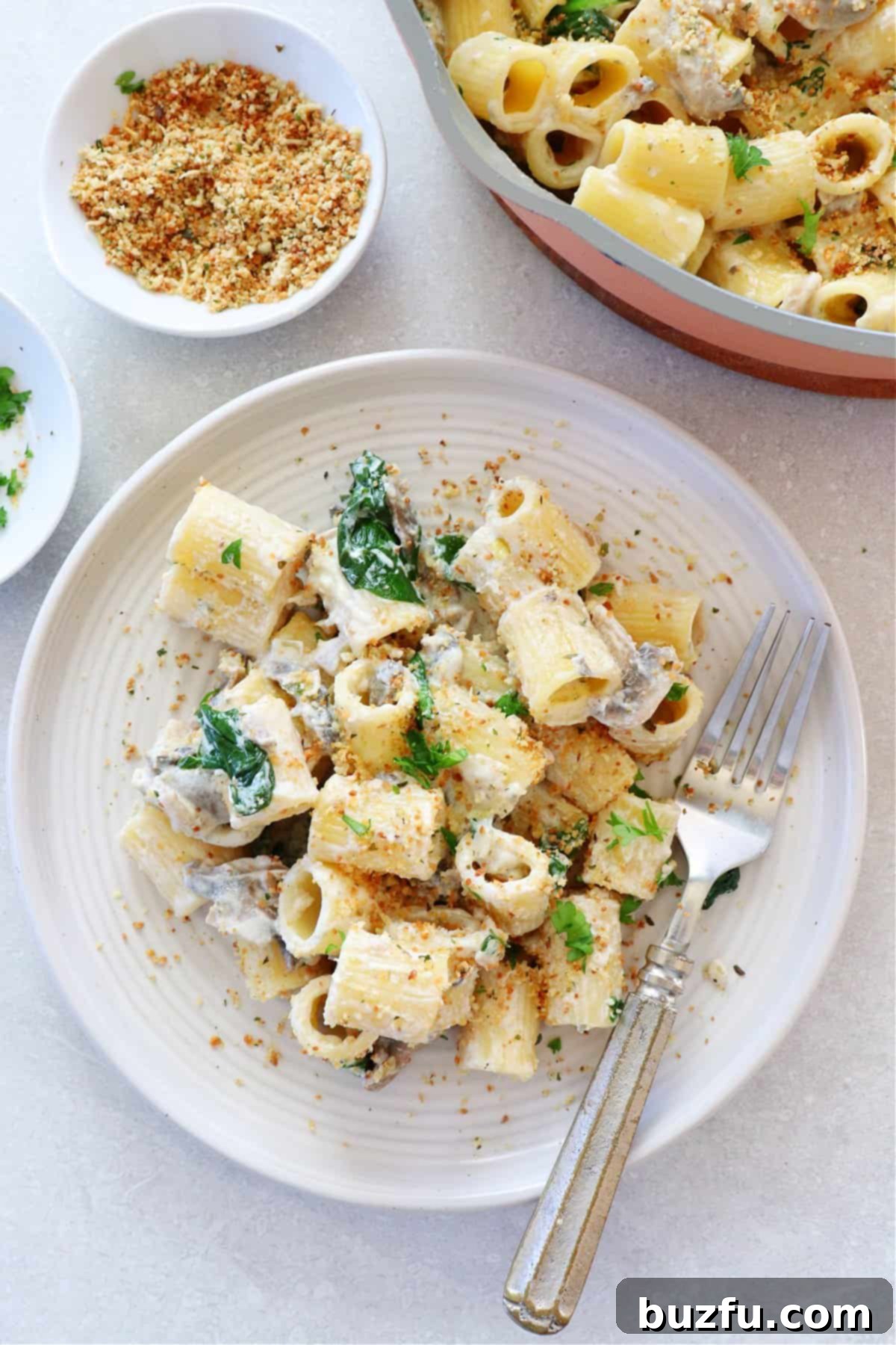 A delectable serving of pasta generously coated with creamy Boursin sauce, presented beautifully on a plate.