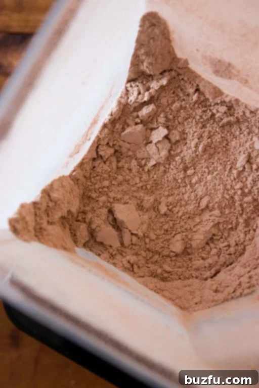 The perfectly blended homemade hot chocolate mix, ready for storage and enjoyment A close-up overhead shot of the finely blended homemade hot chocolate mix inside the blender, showcasing its smooth texture.