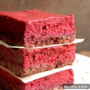 Stacked Red Velvet Cheesecake Bars, showcasing their layers.