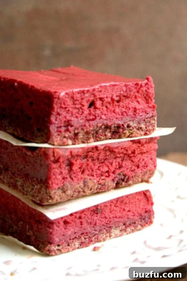 Red Velvet Cheesecake Bars stacked up, ready to be enjoyed.