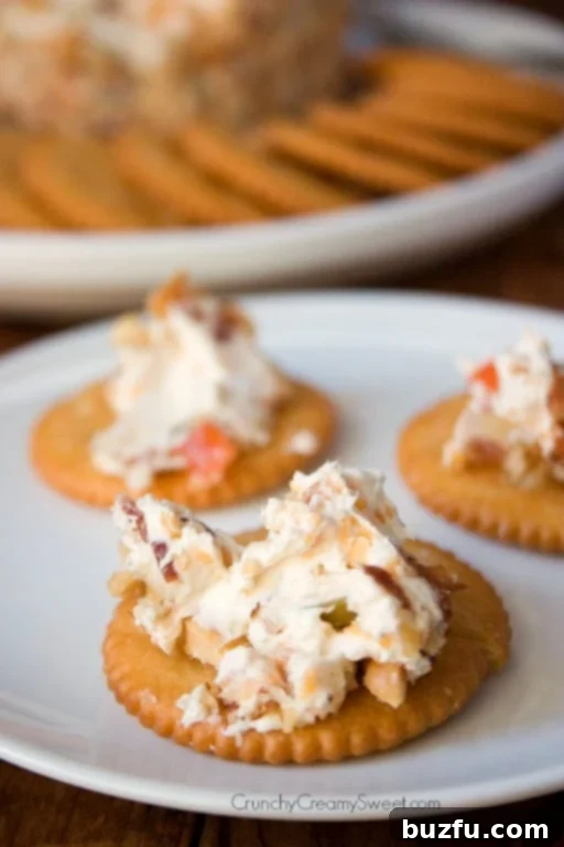Close-up of a creamy cheese ball before being coated in nuts, highlighting its smooth texture