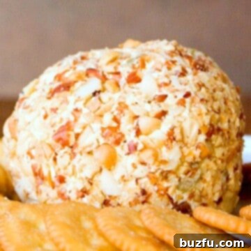 Bacon and Olive Cheese Ball on a plate with crackers.
