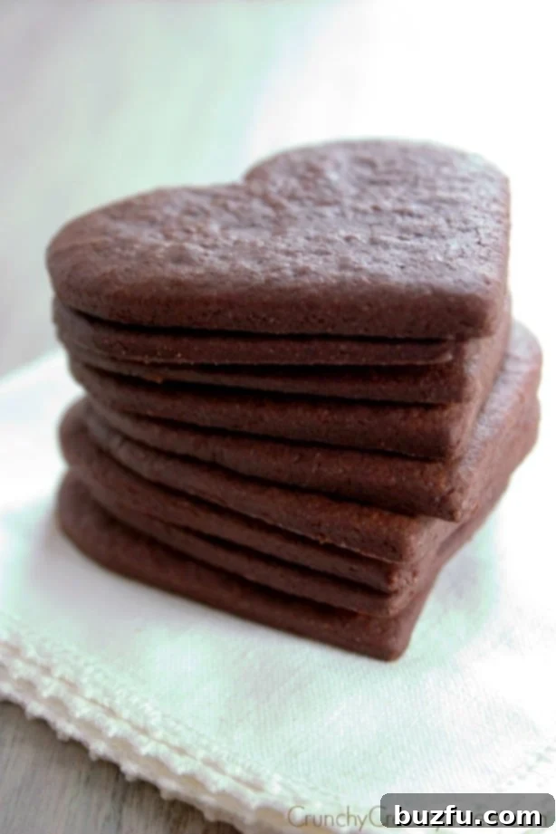 Side shot of a stack of plain shortbread cookies, showcasing their golden, crumbly texture.