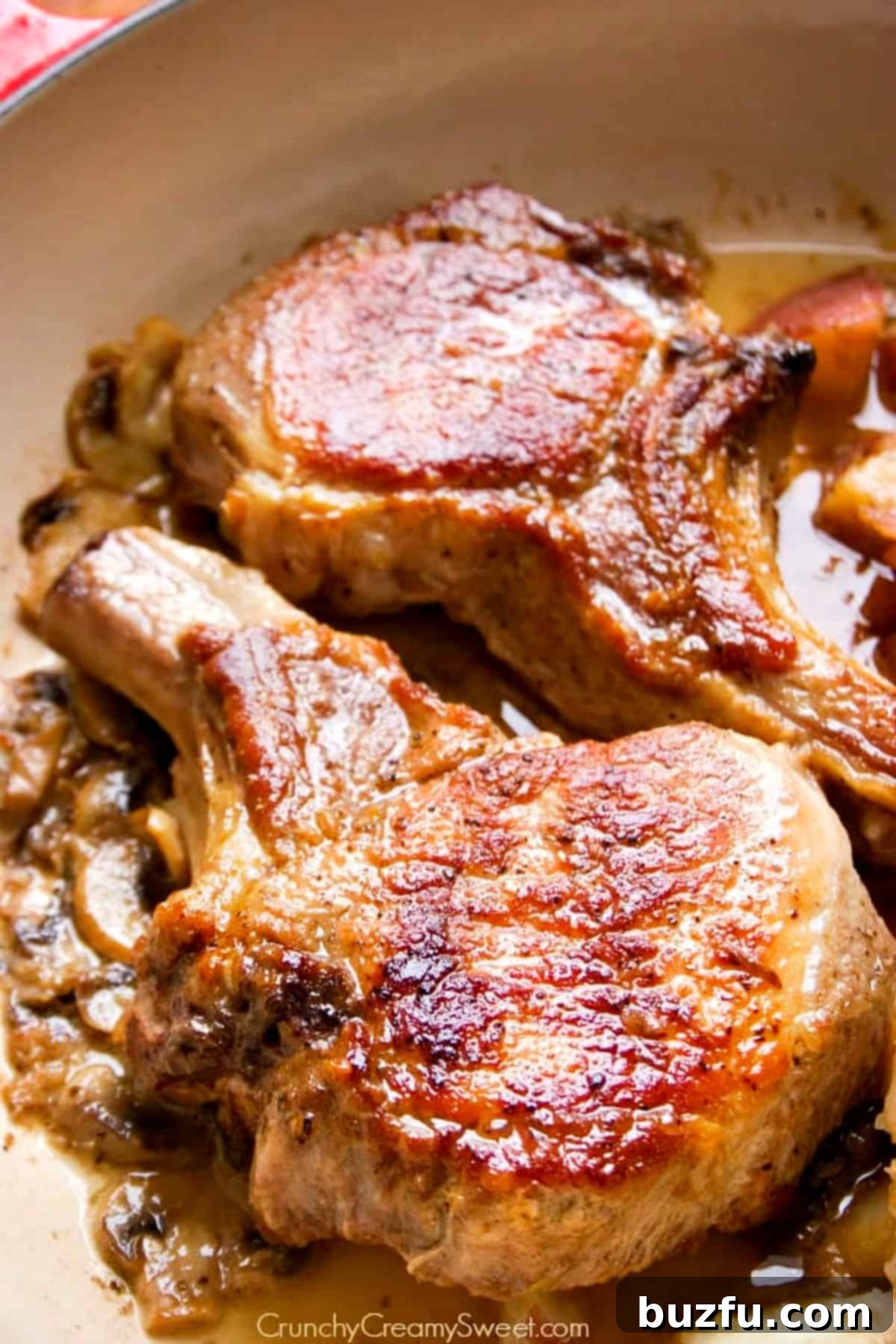 Perfectly seared braised pork chops and potatoes in a skillet, ready to be served.
