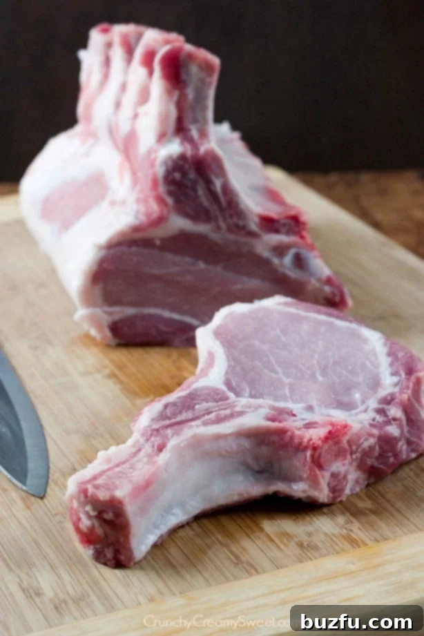 Bone-in pork loin expertly sliced into individual chops, ready for braising.