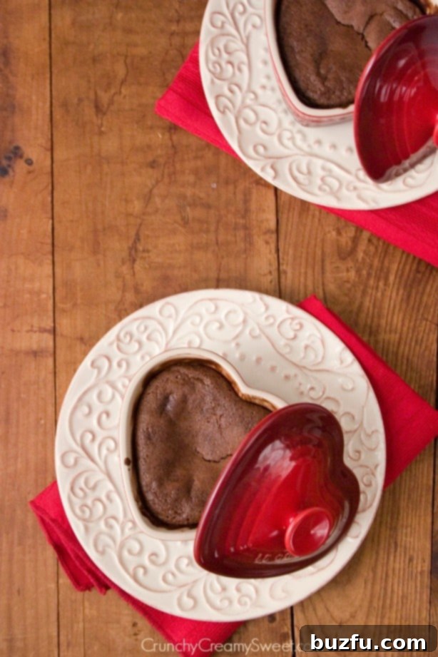Overhead shot of lava cakes in ramekin on plate.