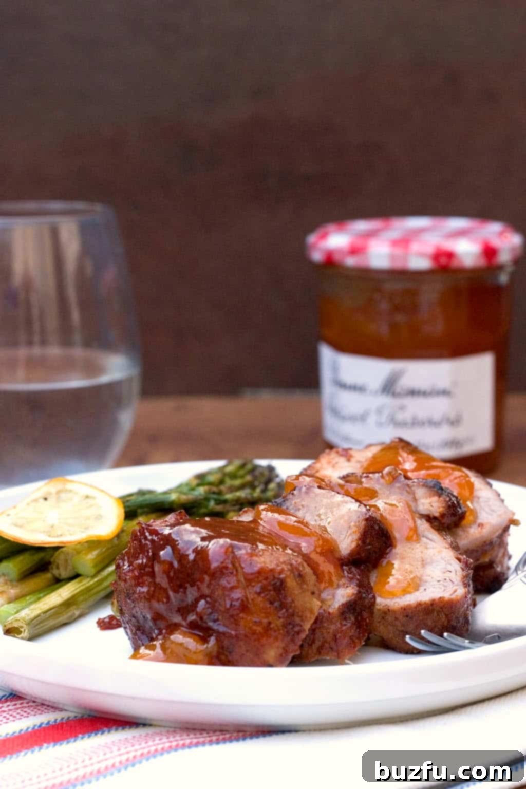 Tangy Apricot BBQ Pork Tenderloin - A Culinary Masterpiece Tangy Apricot BBQ Pork Tenderloin plated beautifully with extra sauce
