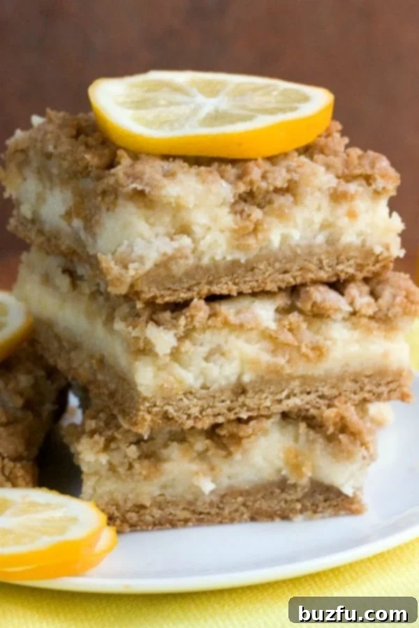 Stack of Lemon Crumb Bars with a bite taken out, showing creamy layers
