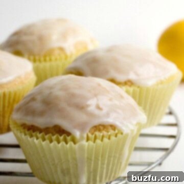 Glazed Lemon Muffins on a rack, freshly baked and ready for glazing.
