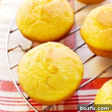 Ultimate Golden Cornbread Muffins 3 Perfect Cornbread Muffins set on cooling rack.