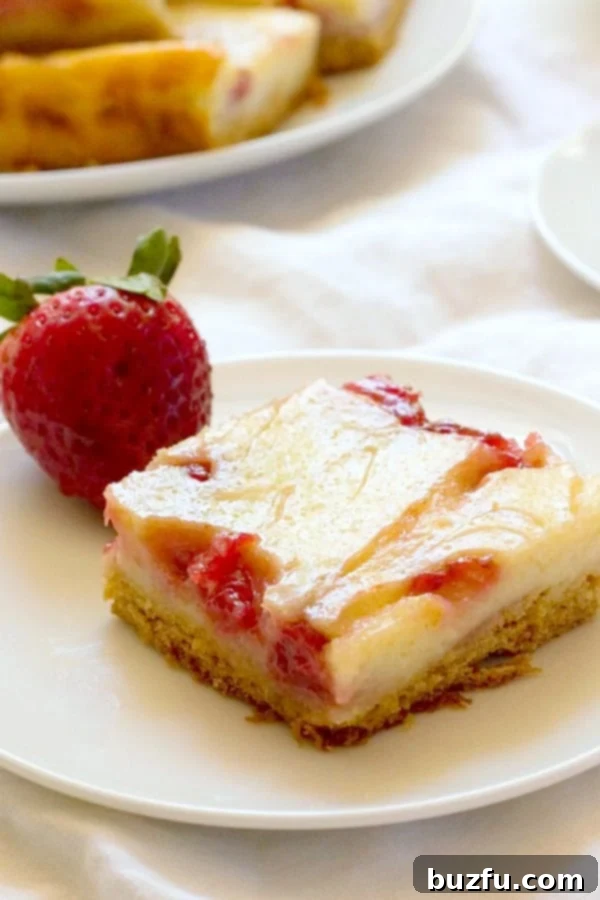 A single Strawberry Jam Swirl Sour Cream Bar on a pristine white plate, showcasing the vibrant red swirl against the creamy yellow base.