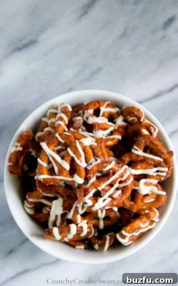 Cinnamon Roll Pretzels - a bowl full of cinnamon sugar coated pretzels with white chocolate drizzle, ready to serve.