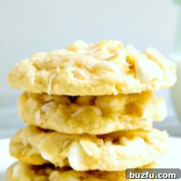 White Chocolate Coconut cookies stacked on plate.
