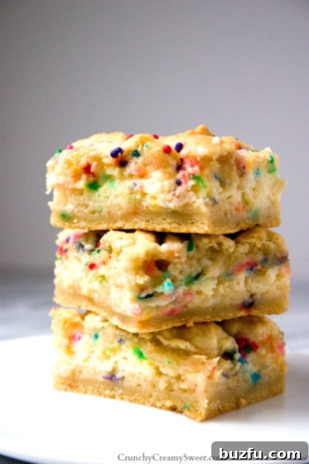 Funfetti Cheesecake Sugar Cookie Bars: Sweet, chewy, and creamy. Bright and colorful Funfetti Cheesecake Sugar Cookie Bars, perfect for celebrations.