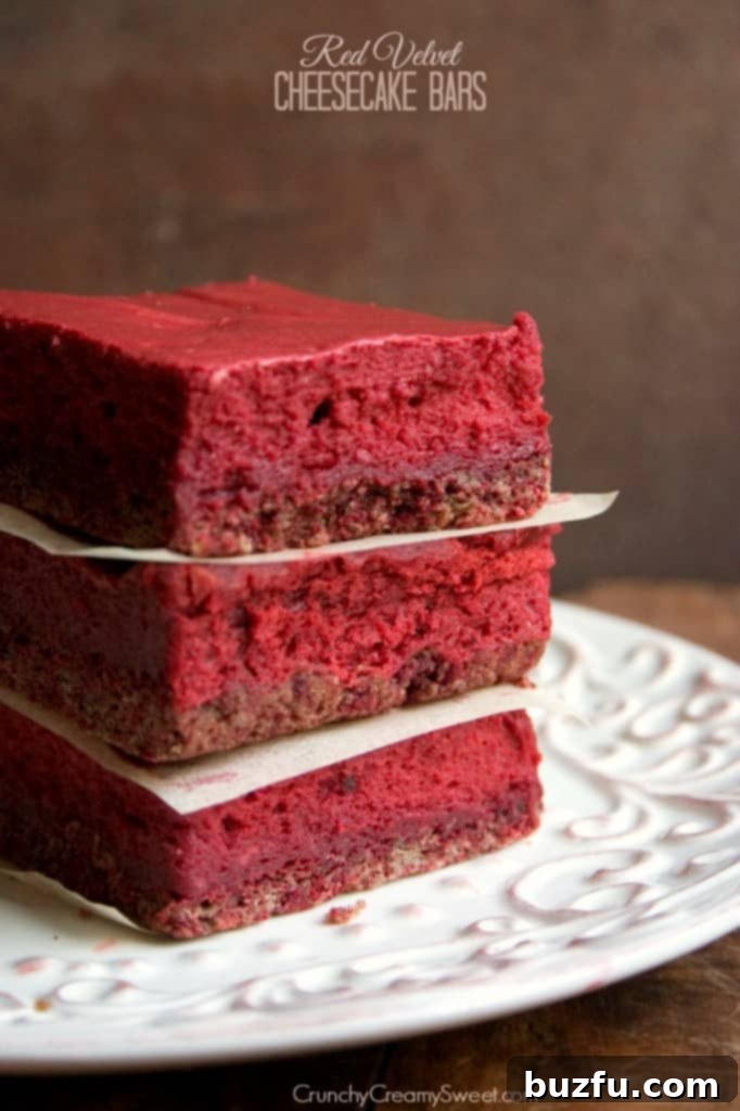 Red Velvet Cheesecake Bars: A luxurious dessert for any occasion. Decadent Red Velvet Cheesecake Bars with cream cheese frosting swirl.