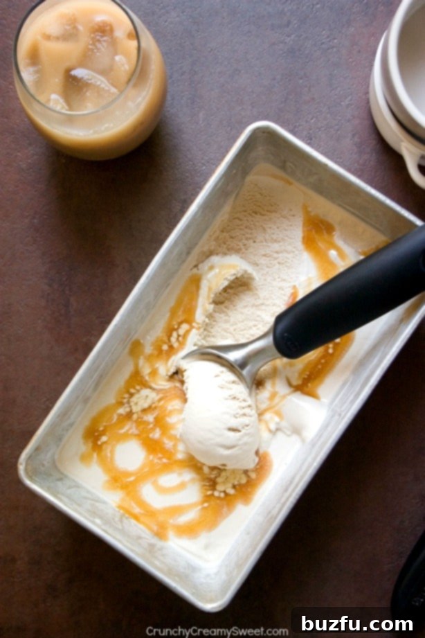 Luscious Iced Coffee Ice Cream with Caramel Swirl A close-up shot of a scoop of Iced Coffee Ice Cream with rich caramel sauce, highlighting its creamy texture.