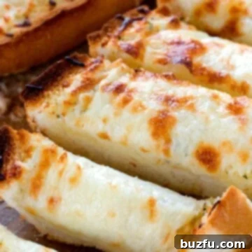 Golden Gooey Garlic Perfection 2 Easy cheesy Garlic Bread sliced on board.