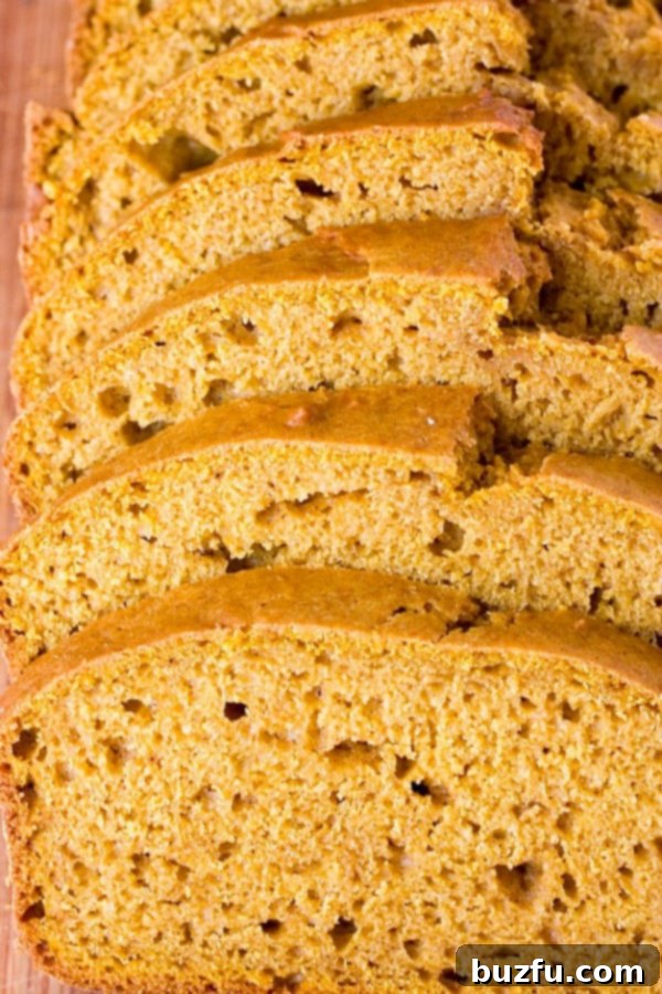 Deliciously sliced Pumpkin Bread with a generous dollop of Cinnamon Cream Cheese Spread.
