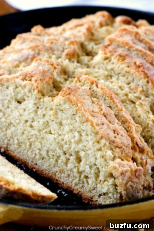 Parmesan Ranch Skillet Bread - quick and easy bread with Parmesan cheese and ranch seasoning! So good! Perfect with a bowl of soup, chili or pasta! Sliced Parmesan Ranch Bread in a skillet, showcasing its golden crust and soft interior, ready to be served.