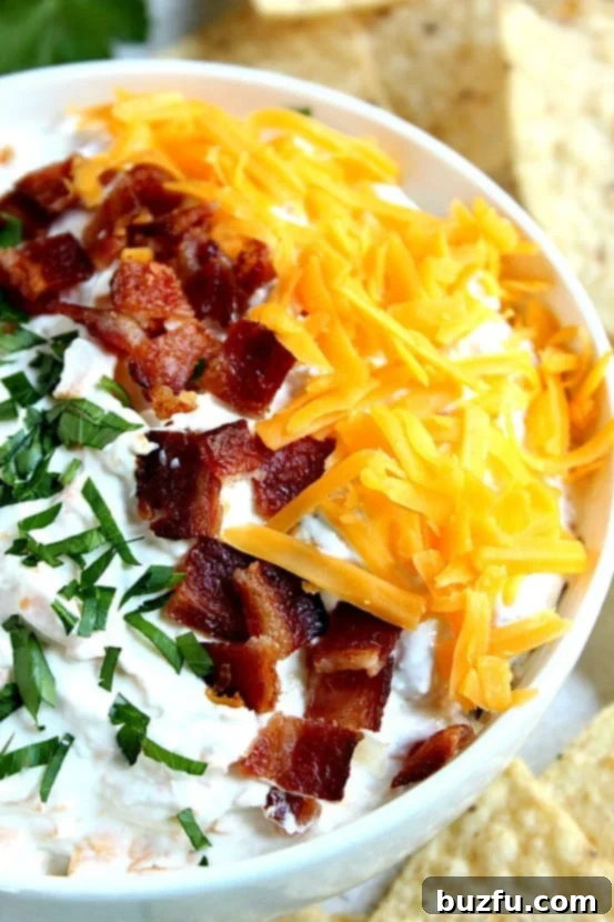 Cheddar Bacon Ranch Dip: An easy 5-ingredient appetizer for any occasion. Creamy Cheddar Bacon Ranch Dip in a bowl with chips and vegetables, perfect for game day or parties.