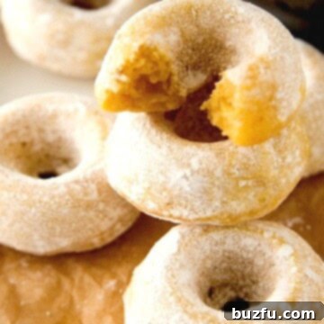 Mini Sugar Pumpkin Donuts stacked up.