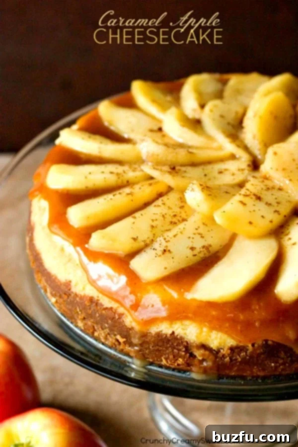 Decadent Caramel Apple Cheesecake with homemade caramel topping and fresh apple slices. Side shot of a perfectly baked caramel apple cheesecake with glistening apple slices and rich caramel sauce on top, resting on an elegant glass cake stand.