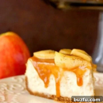 Decadent Caramel Apple Cheesecake 3 Slice of cheesecake with apples and caramel, on plate.