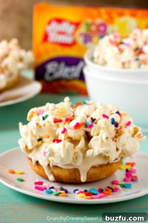 Sweet & Salty Confetti Pop Donuts 2 White Chocolate Funfetti Popcorn Donuts - a delightful blend of donuts, white chocolate, funfetti, and popcorn.