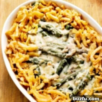 Green bean casserole in white oval baking dish.