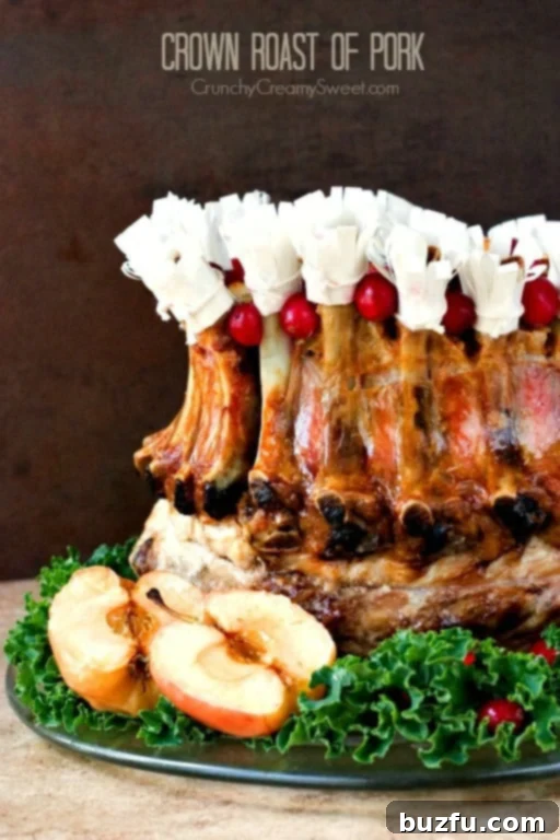 Crown Roast of Pork - impressive centerpiece for your holiday table Crown Roast of Pork with decorative paper hats on a platter, garnished with fresh lettuce.