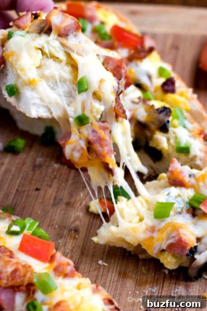 Breakfast Omelet Cheesy Garlic Bread Breakfast Omelet Cheesy Garlic Bread - a hearty and flavorful breakfast creation featuring eggs, bacon, ham, vegetables, and lots of cheese on a garlic bread base.