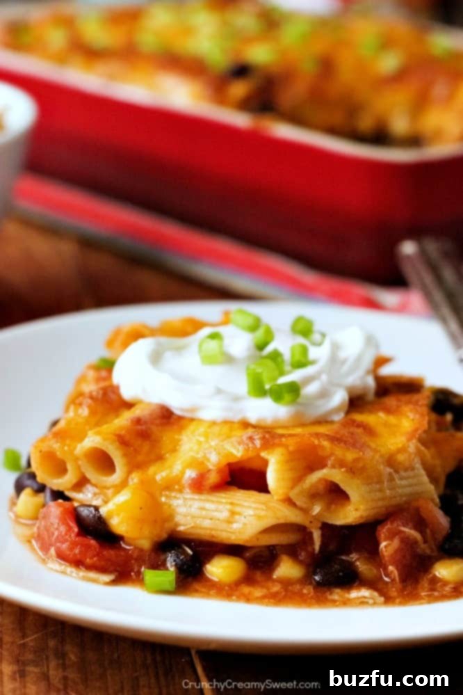 Close-up shot of the Cheesy Chicken Enchilada Pasta Bake, highlighting the texture and melted cheese.