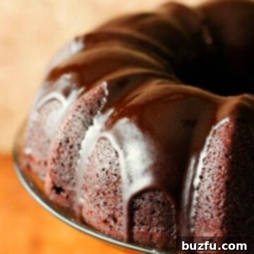 Decadent Chocolate Bundt Cake 3 Chocolate Bundt Cake with glaze on cake stand.