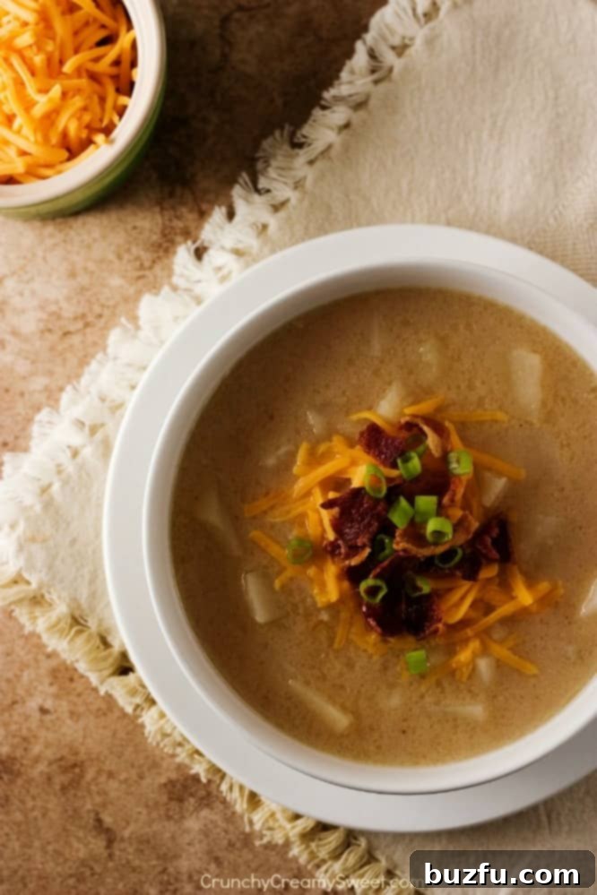 Hearty Crockpot Baked Potato Soup garnished with fresh chives