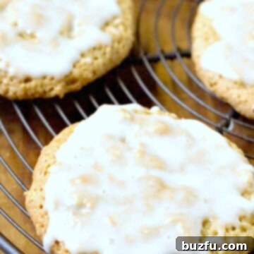 Old Fashioned Iced Oatmeal Cookies on a cooling rack, freshly baked and ready to be glazed.