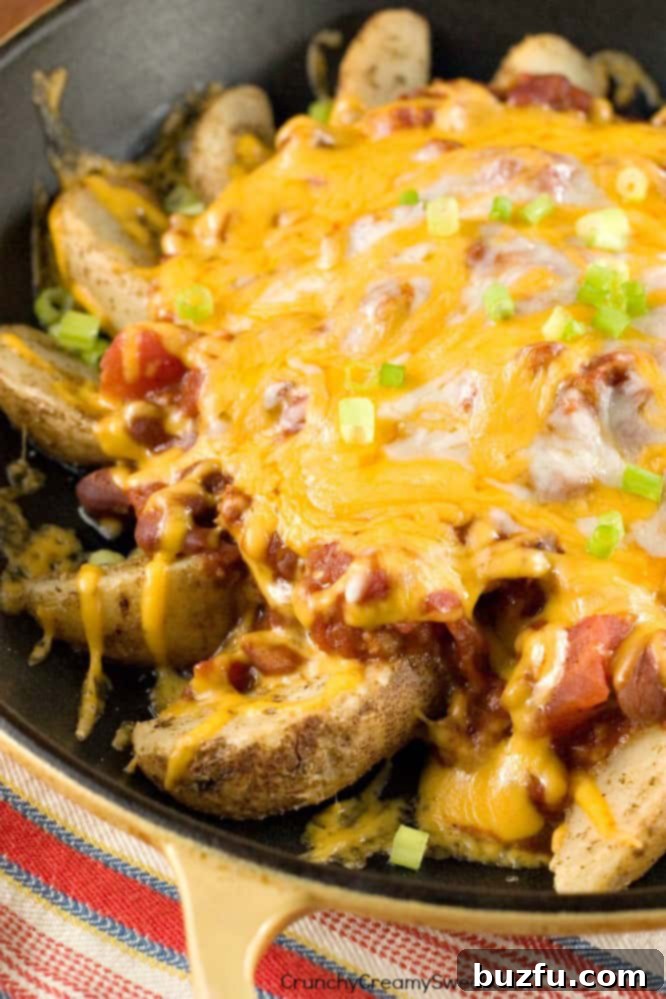 Delicious Lightened Up Chili Cheese Fries featuring Alexia Oven Fries with melted cheese and turkey chili, perfect for a healthier comfort food alternative.