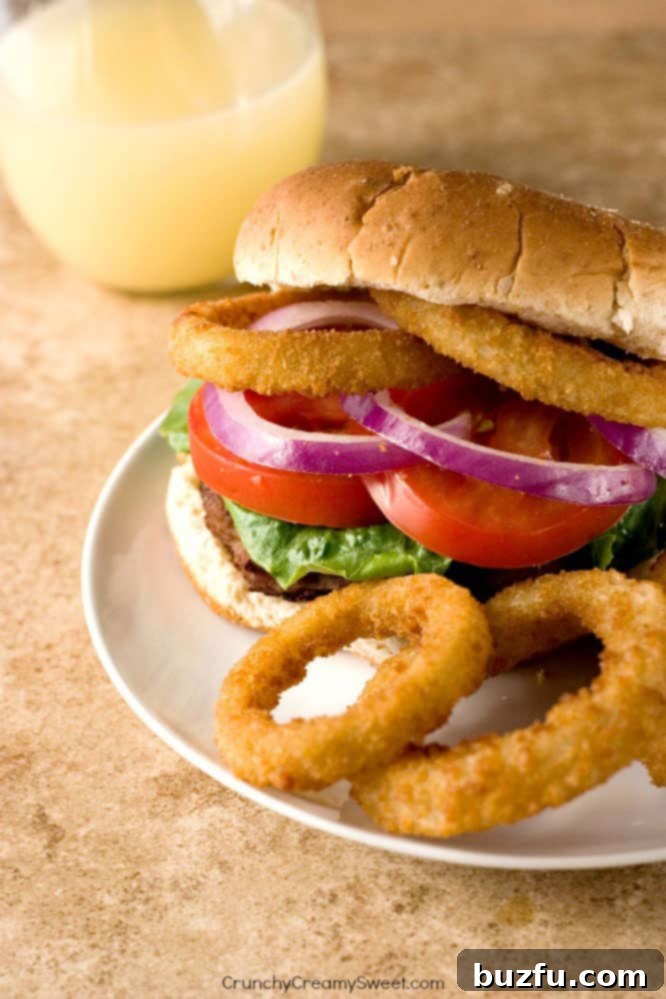 Hearty Turkey Burger on a whole wheat bun with fresh toppings, served with Alexia Onion Rings.