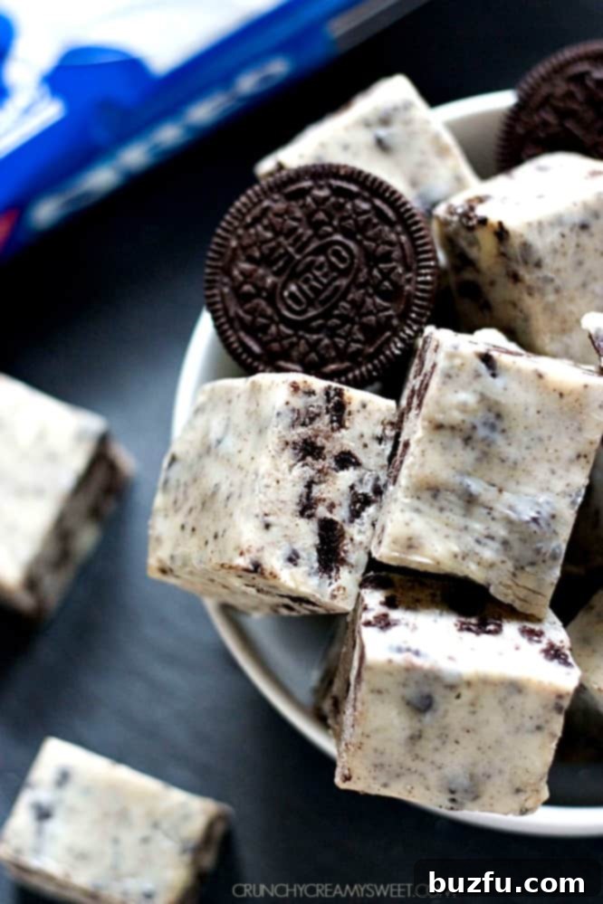 Make Easy Cookies and Cream Oreo Fudge for any occasion Delicious Oreo fudge squares neatly arranged in a white bowl, showcasing their irresistible cookies and cream texture.