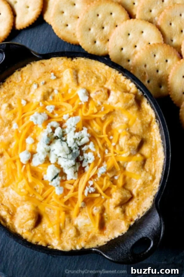 Buffalo chicken dip in black cast iron skillet.