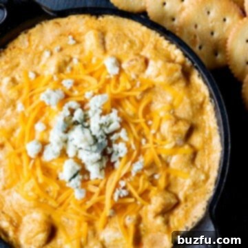 Buffalo chicken dip in black cast iron skillet.