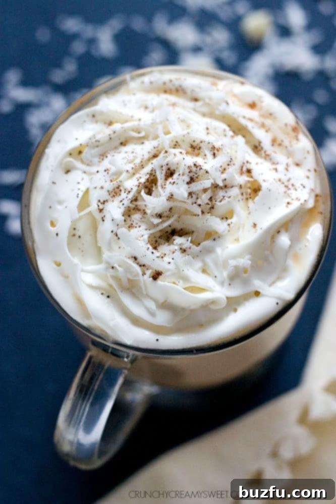 Sweet and Creamy White Chocolate Coconut Latte topped with whipped cream and shredded coconut