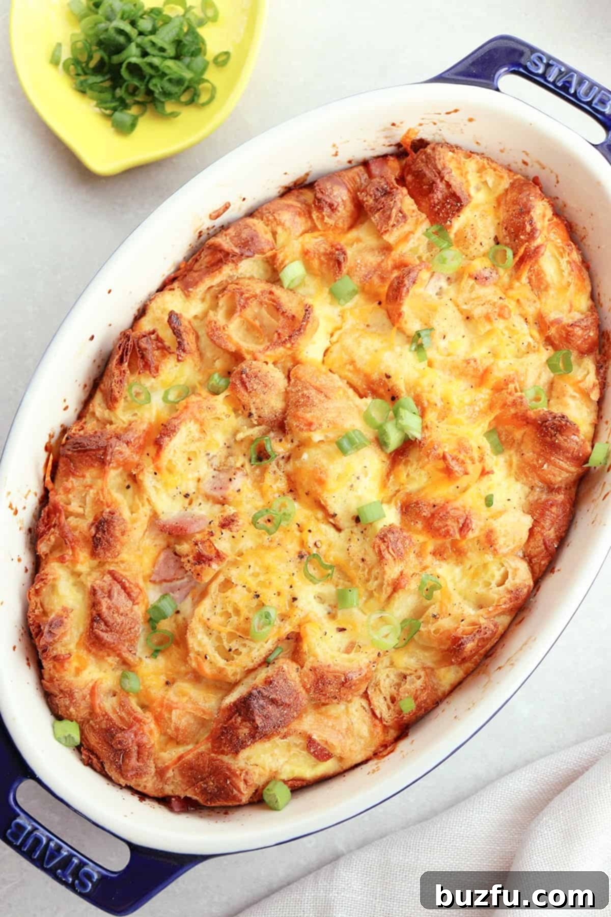 Overhead photo of croissant, ham, cheese, and egg bake for breakfast or brunch.